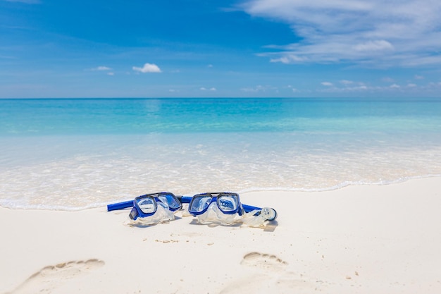 Summer beach scenery with snorkel gear googles on soft sand, recreational activity freedom adventure