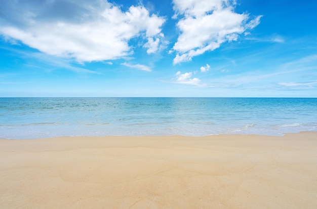 Summer beach sea season greeting background Tropical sandy beach with blue ocean and blue sky clouds background image for nature background or summer background