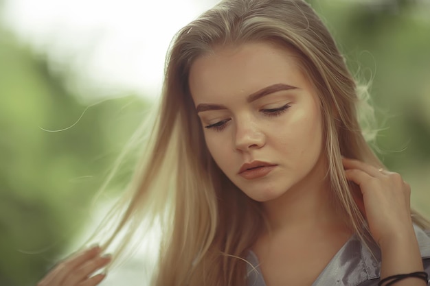 Summer beautiful young blonde in the park