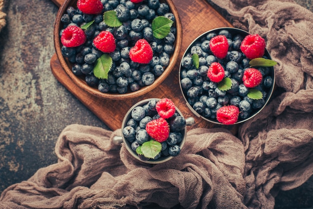 Summer Berries mix with Raspberry, Blueberry in wooden and metal dishes