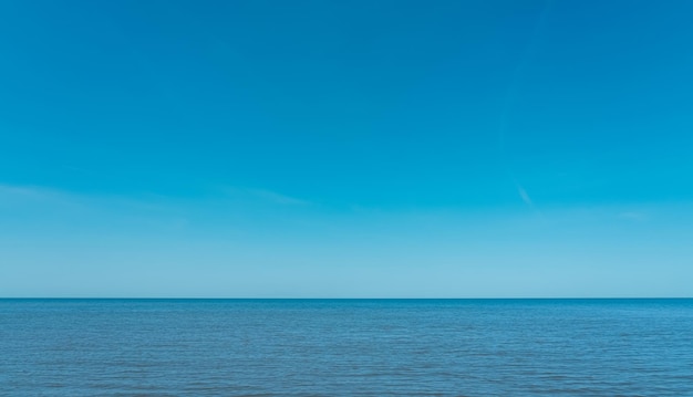 Summer Blue Sky Over Blue Ocean BackgroundBeautiful Nature Tropical Beach with Clear Sky and White Clouds Abstract Texture with Copy SpaceSummer vacation or holiday business travel banner concept