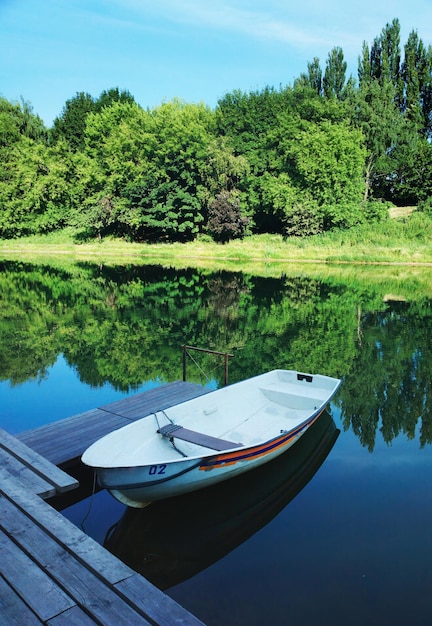 Summer boat in park landscape backdrop