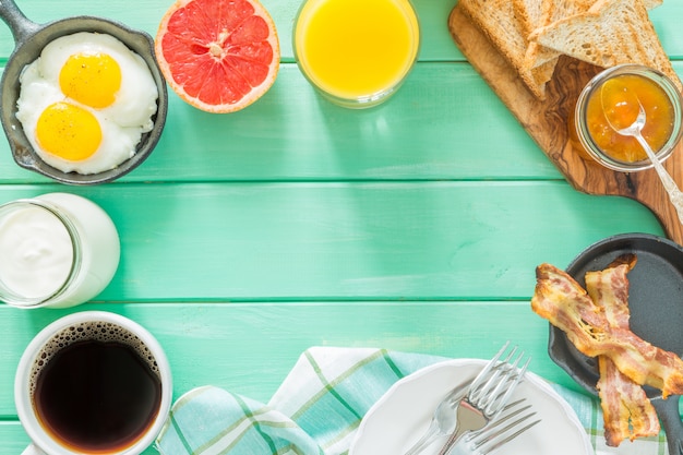 Summer breakfast - eggs, bacon, toast, jam, coffee, juice