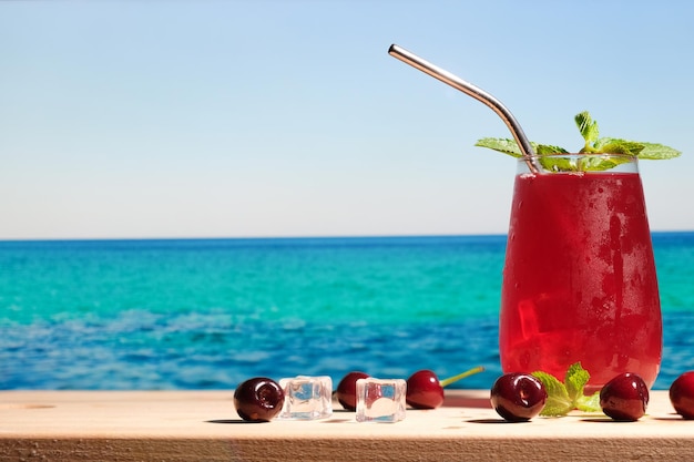 Summer cherry cocktail on beach bar