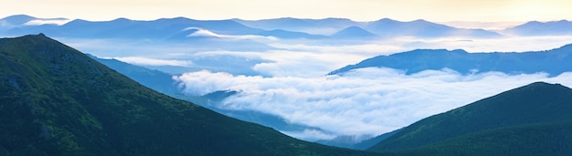 Summer cloudy sunrise mountain panorama view (Ukraine, Carpathian Mountains). Three shots stitch image.