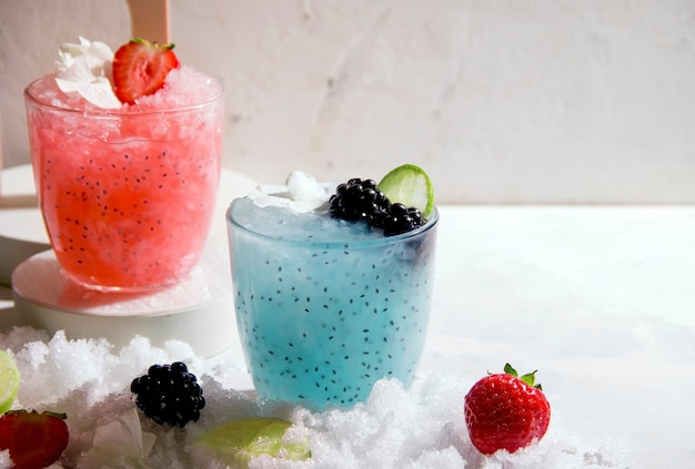 Summer cocktails with ice and lime from berries on a white background