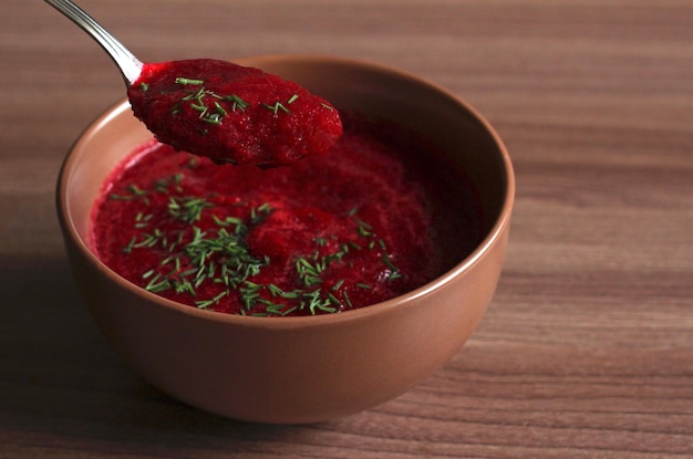 Summer cold beet soup with greens and cucumbers