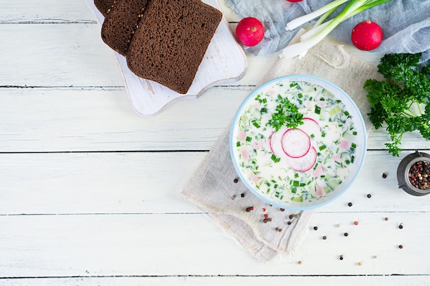 Summer cold soup with yogurt and vegetables Traditional russian cold soup okroshka Top view