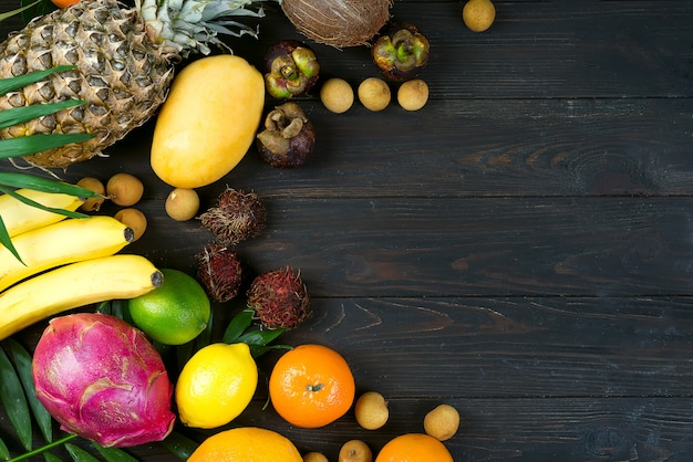 Summer colorful concept border with tropical fruits and leaves