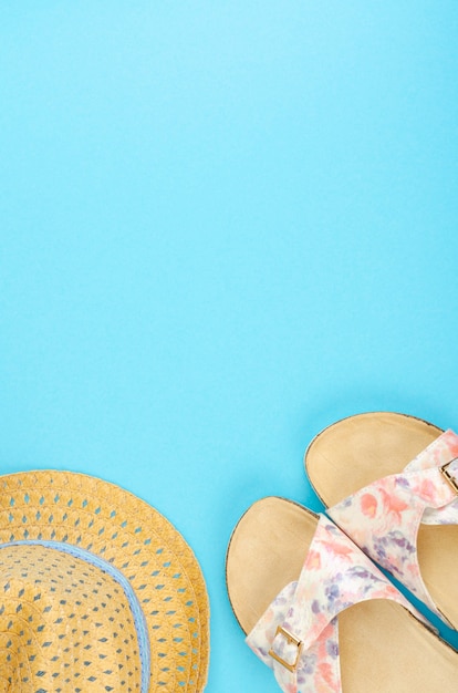 Summer composition of hats and shoes on bright surface