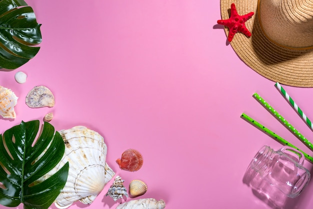 Summer composition. Tropical palm leaves, hat, seashells on pastel violet background