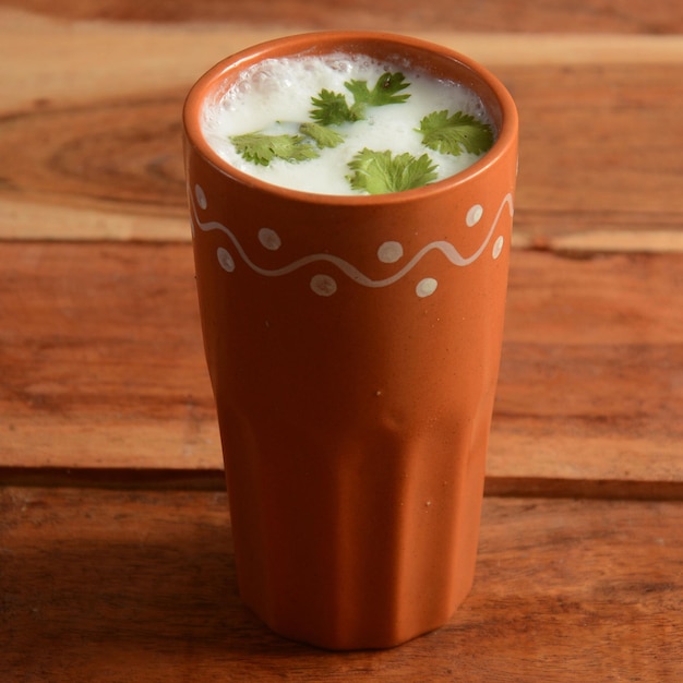 Summer cooler Buttermilk drink Made of yogurt served in a traditional clay pot selective focus on top