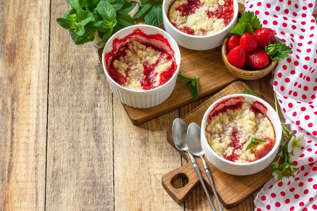 Summer dessert home cooking Strawberries crumble in a baking dish and fresh strawberries Copy space