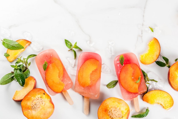 Summer desserts. Frozen drinks. Sweet fruit popsicles from frozen peach tea with mint