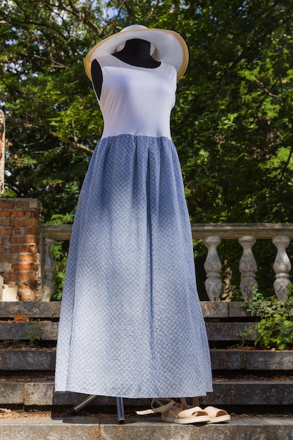 Summer dress of jersey White blue dress on mannequin Female sarafan made of natural fabric Natural background