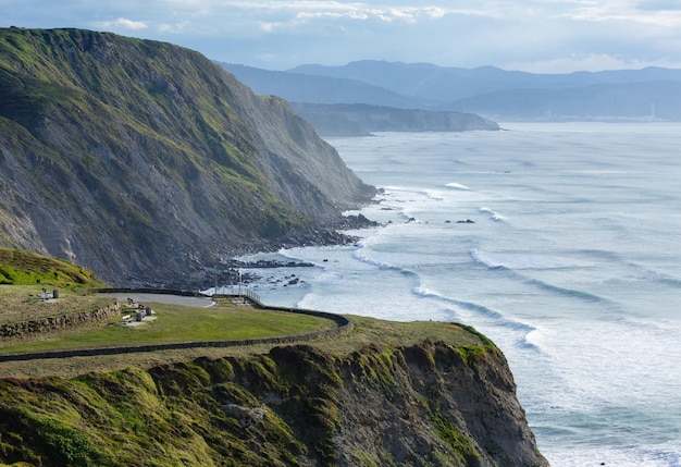 Summer evening ocean coastline view near beach in Barrika town, Biscay, Basque Country (Spain).