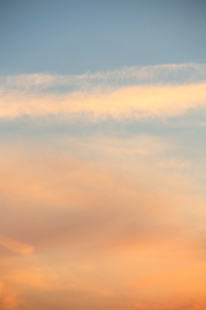 summer evening sunset in yellow orange and pink with clouds background