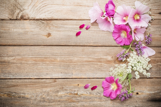 Summer flowers on old wooden background