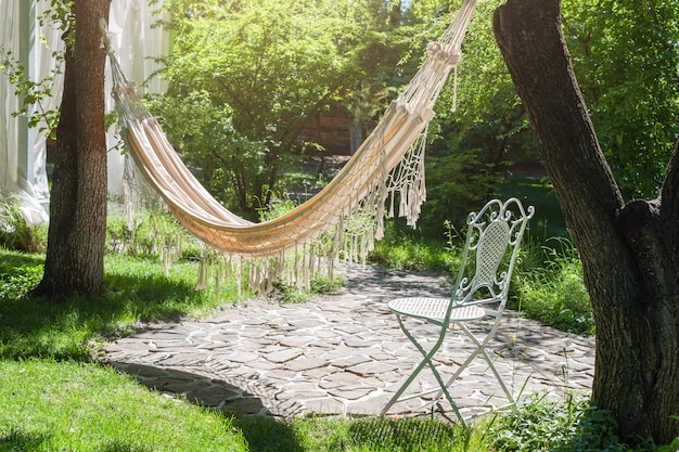 Summer garden with hanging hammock for relaxation.