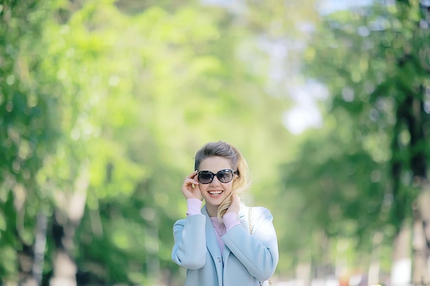 summer girl outdoor air / cheerful adult girl model on a summer walk in the city park, happiness, pleasure freedom