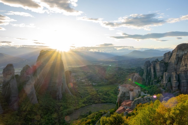 Summer Greece. Sunset over valley of the rock monasteries in Meteora and sunbeams