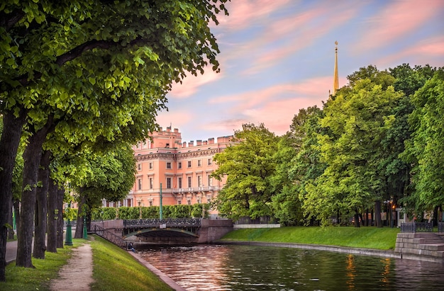 Summer greens at the Mikhailovsky Castle in the early morning and pink colors in the sky