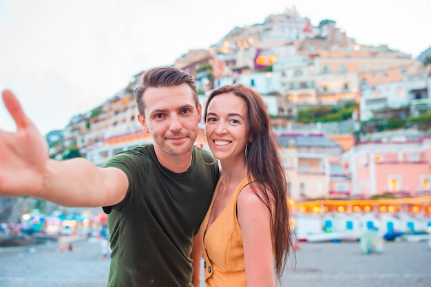 Summer holiday in Italy. Young couple in Positano village, Amalfi Coast, Italy