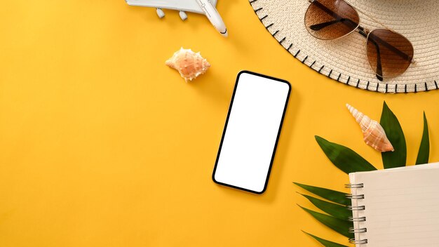 Summer holiday vacation background with accessories and smartphone mockup on yellow background