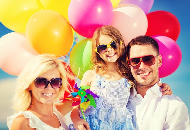 summer holidays, celebration, children and people concept - family with colorful balloons