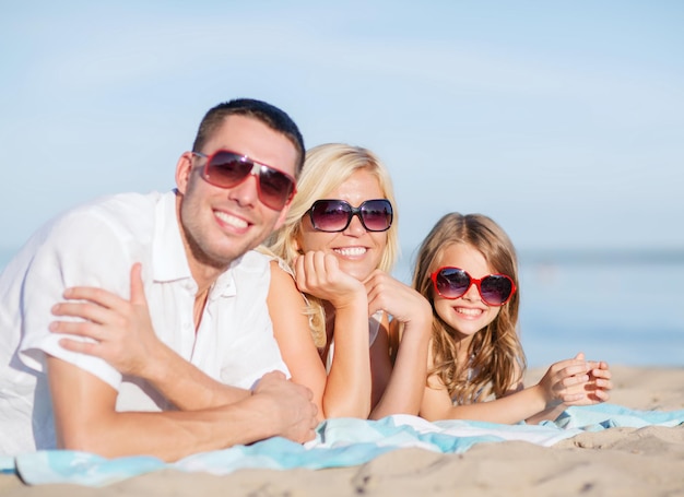 summer holidays, children and people concept - happy family on the beach