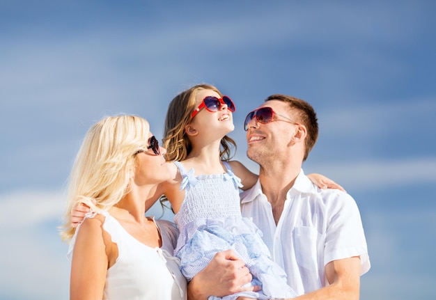 summer holidays, children and people concept - happy family with blue sky