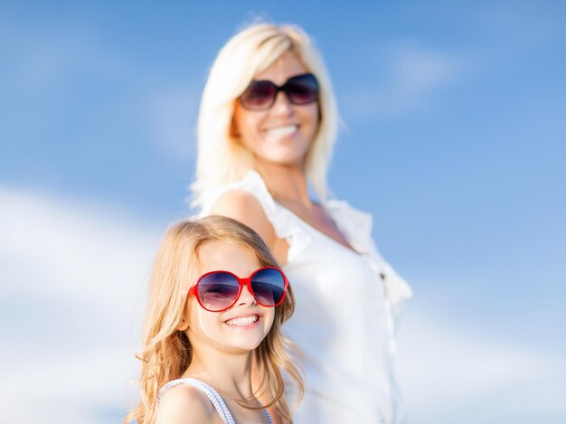 summer holidays, family, children and people concept - mother and child in sunglasses