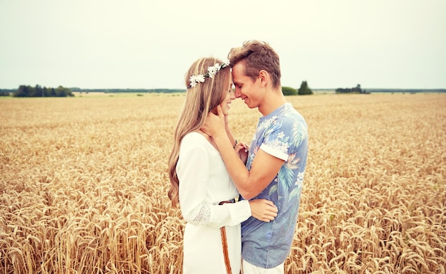 summer holidays, love, romance and people concept - happy smiling young hippie couple hugging outdoors