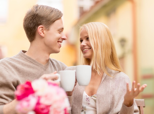 summer holidays, love, travel, tourism, relationship and dating concept - romantic happy couple in the cafe