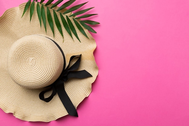 Summer holidays Summer concept with straw hat and tropical leaf Flat lay top view copy space