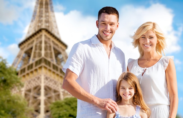 summer holidays, travel, tourism and people concept - happy family in paris over eiffel tower background