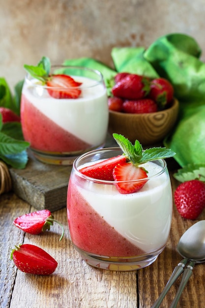 Summer italian dessert Panna cotta with strawberry jelly and fresh strawberries