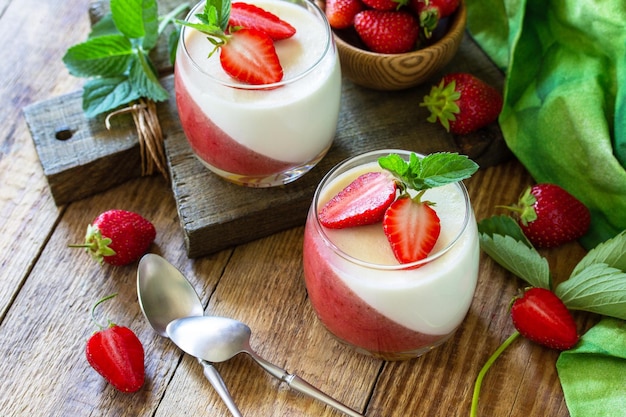 Summer italian dessert Panna cotta with strawberry jelly and fresh strawberries