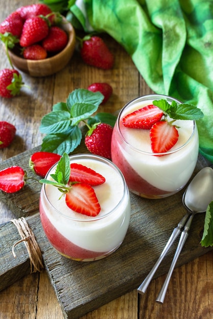 Summer italian dessert Panna cotta with strawberry jelly and fresh strawberries