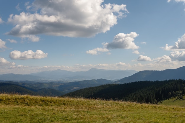 Summer landscape in mountains and the dark blue sky with clouds. Landscape from Bucegi Mountains, part of Southern Carpathians in Romania in a very foggy day