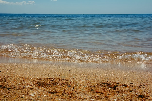 Summer landscape with sea waves lapping at the seashore