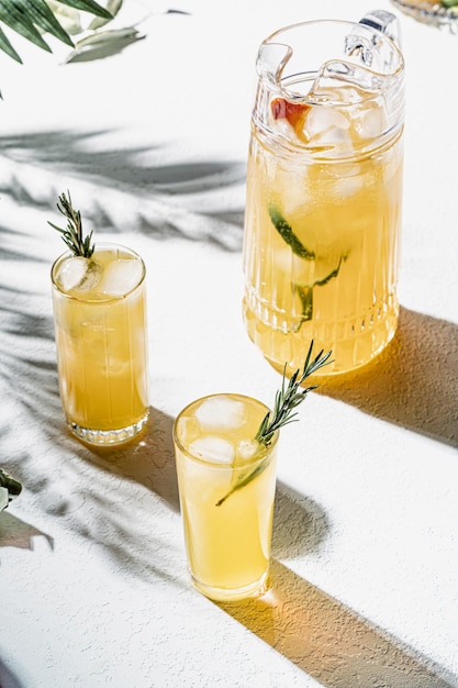 Summer lemonade in jug and glass on table