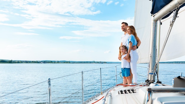 Summer Moments. Family Standing On Yacht Deck Sailing Across The Sea Outside. Free Space For Text, Panorama