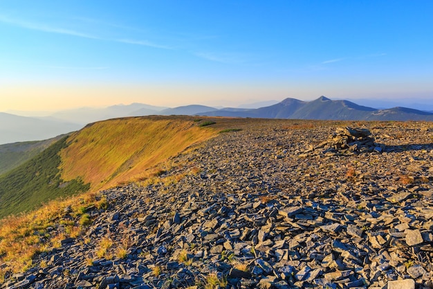 Summer morning Carpathian mountain top view from stony summit of Ihrovets Mount (Gorgany, Ukraine).