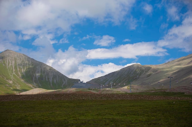 Summer mountain landscape and a cable car in the distance