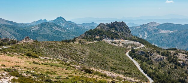 Summer mountain landscape with alpine road (Sierra Nevada National Park, near Granada, Spain).