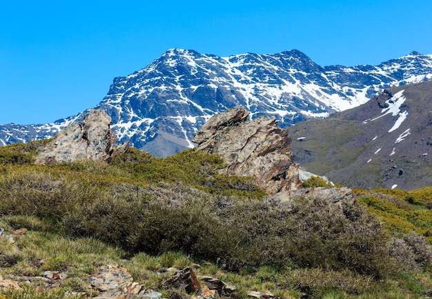 Summer mountain landscape with snow on slope Sierra Nevada National Park near Granada Spain