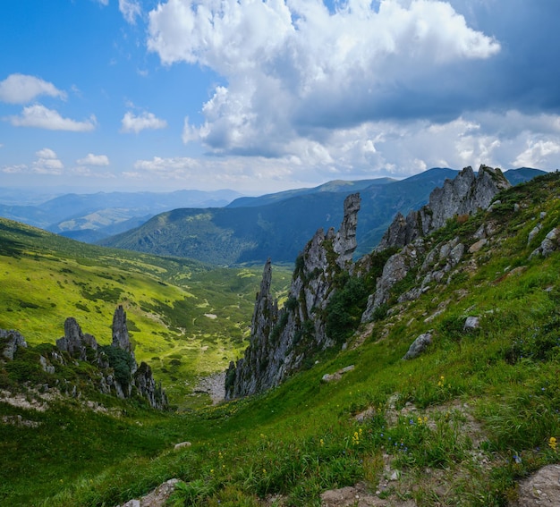 Summer mountain slope with picturesque rock formations Shpyci mountain Carpathian Ukraine