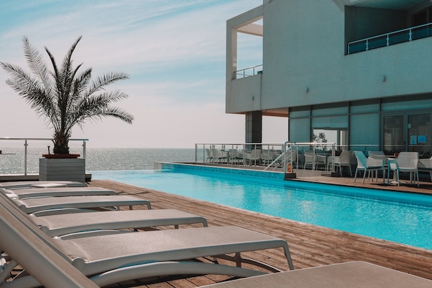 Summer outdoor swimming pool and sun loungers. In the hotel to rest.