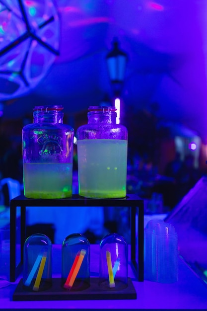 Summer party with neon lights and neon cocktail drinks